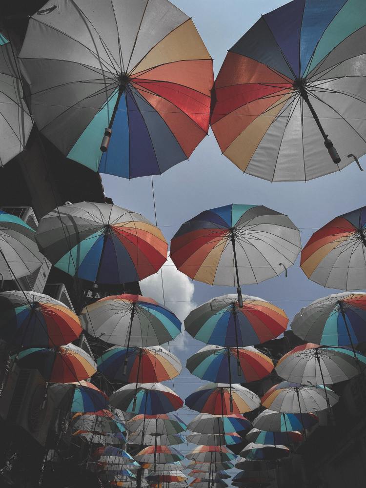Several umbrellas hanging in above the photographer